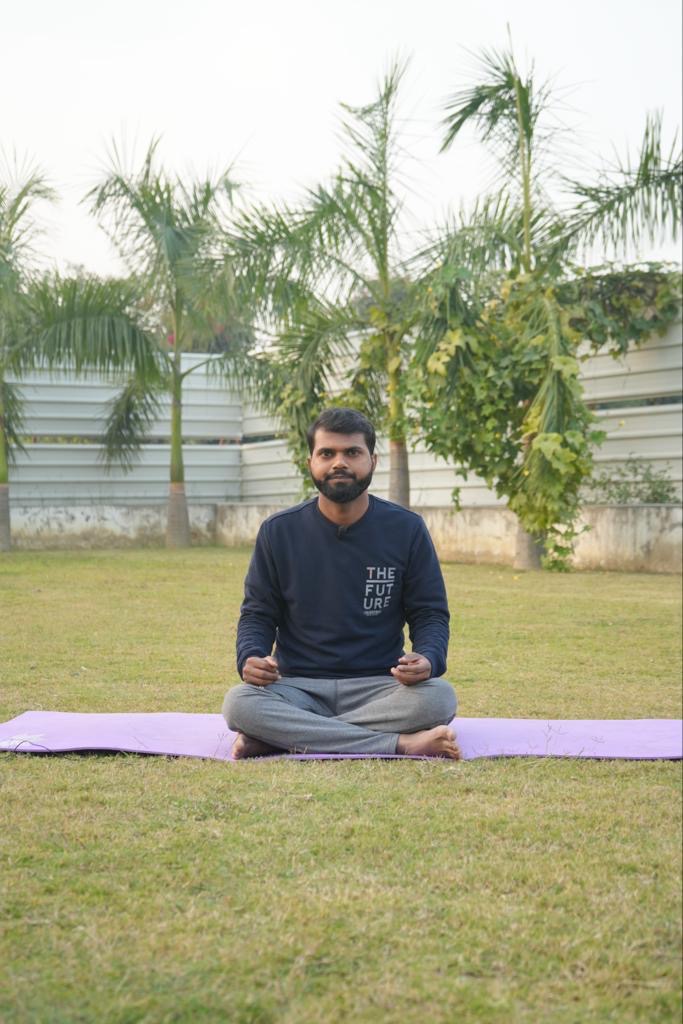 Dheeraj Shah in a seated meditation pose